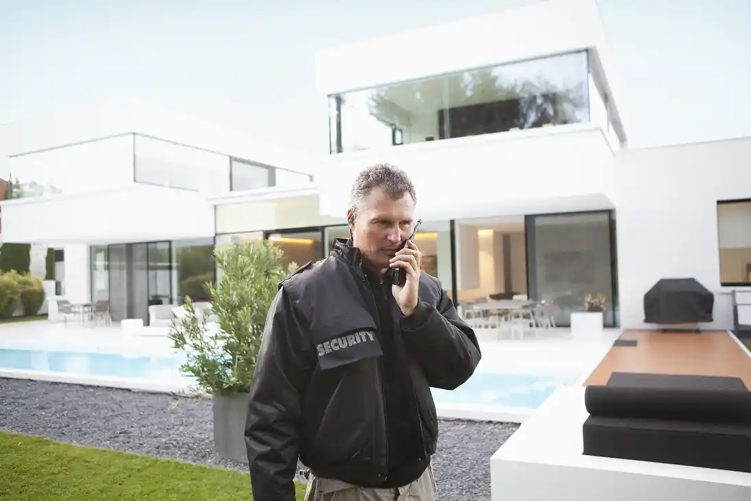 mature-security-man-using-walkie-talkie-in-grounds-2026-01-11-10-02-52-utc 1